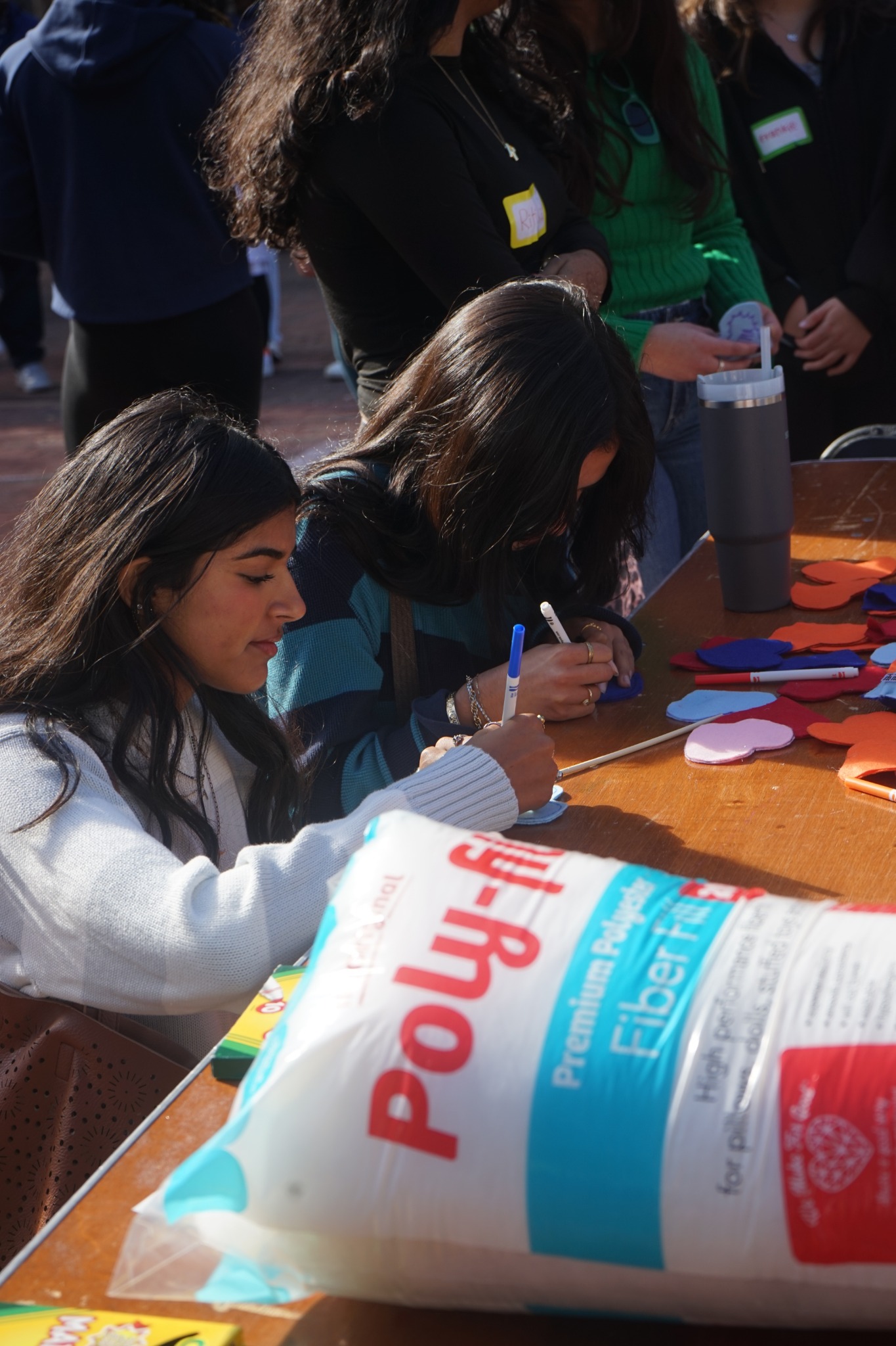 OTHA volunteers decorating felt pieces at a community event