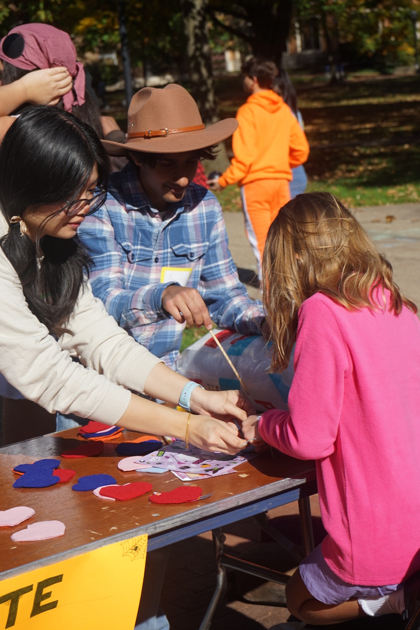 OTHA volunteers helping with a felt-heart craft activity
